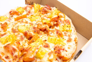 Close up of a Pizza in a cardboard box against on white background.Pizza delivery. Pizza menu.