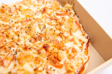 Close up of a Pizza in a cardboard box against on white background.Pizza delivery. Pizza menu.