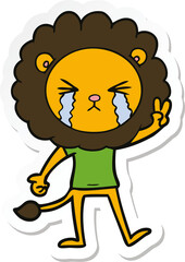 sticker of a cartoon crying lion giving peace sign