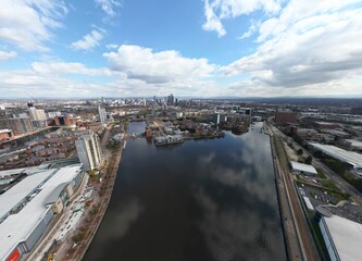 Aerial  of Salford Quays with views towards Manchester city centre and modern skyscrapers. 