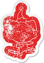 cartoon distressed sticker of a dog dancing wearing santa hat