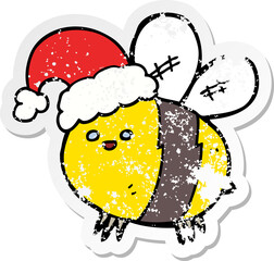 distressed sticker of a cute cartoon bee wearing christmas hat