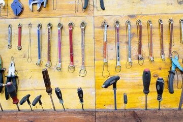 detail of tools fixed with drawing to arrange them on wood in community workshop