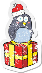 retro distressed sticker of a cartoon christmas penguin