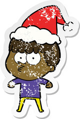 distressed sticker cartoon of a curious boy wearing santa hat