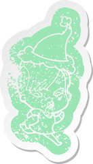 cartoon distressed sticker of a surprised girl wearing santa hat