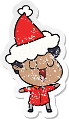 laughing distressed sticker cartoon of a man wearing santa hat