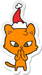cute sticker cartoon of a cat wearing santa hat