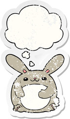 cartoon rabbit and thought bubble as a distressed worn sticker