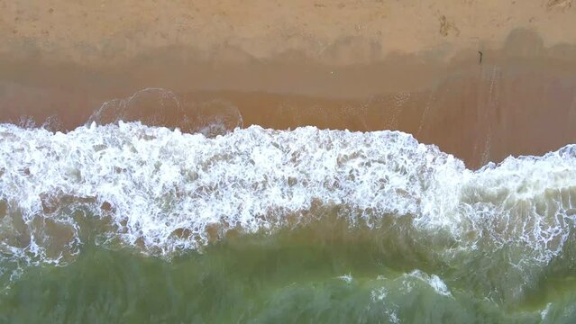 Aerial view of sand beach and water surface texture.