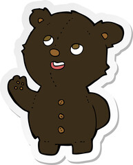 sticker of a cartoon cute black bear cub