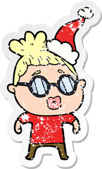 distressed sticker cartoon of a woman wearing spectacles wearing santa hat