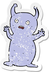 retro distressed sticker of a cartoon funny little alien