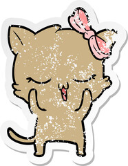 distressed sticker of a cartoon cat with bow on head