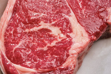 Raw beef fillet steak on white marble background, top view. Steak meat. Close up