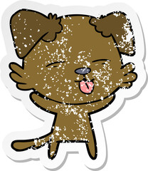 distressed sticker of a cartoon dog sticking out tongue