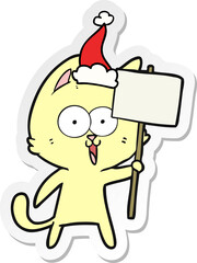 funny sticker cartoon of a cat with sign wearing santa hat