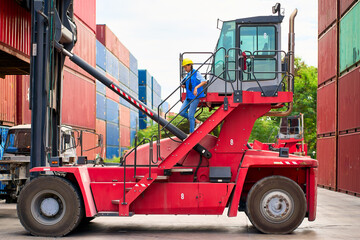 Foreman asian female working on folk-lift car for stacking container box in import export yard site