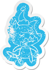 cartoon distressed sticker of a dead fox wearing santa hat