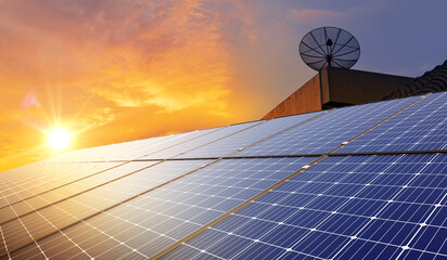 solar panel And electric wind turbines at sunset. Renewable, clean and sustainable energy for...