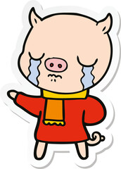 sticker of a cartoon crying pig wearing scarf
