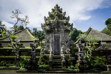 Balinese traditional gate during the day with blue sky background.