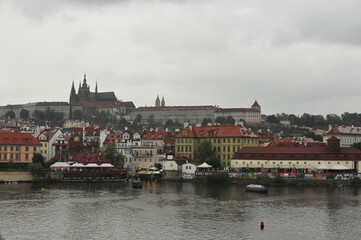 Obraz premium View of the Vltava River and Charles Bridge in the rain. Prague, Czech Republic