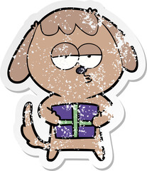 distressed sticker of a cartoon bored dog with christmas present