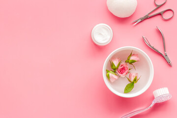 Manicure set with roses water in bowl. Herbal hands care cosmetic set.