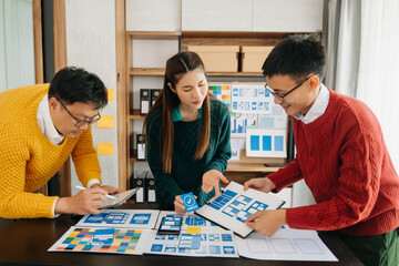 Fototapeta premium Asian businessman and woman people meeting in office. Employee brainstorm and work as team, plan and discuss project by point on paper and tablet. .