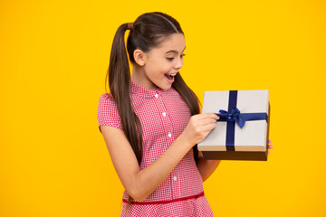 Happy teenager, positive and smiling emotions of teen girl. Child with gift present box on isolated...