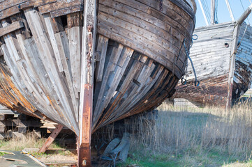 Old derelict wooden ship wreck closeup. Front side of an old abandoned boat coastline In Estonia