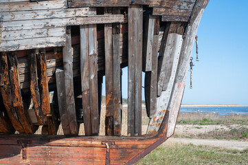 Old derelict wooden ship wreck closeup. Wooden ship ribs, planking, and decking.