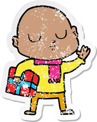 distressed sticker of a cartoon bald man with xmas gift