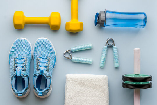 Workout sport accessories with sneakers and towel, top view