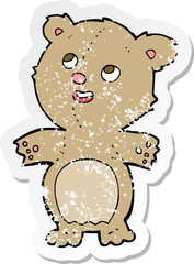 retro distressed sticker of a cartoon happy little teddy bear