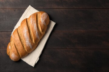 baked bread, delicious freshly baked bread resting on a kitchen towel on a black wooden table