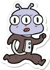sticker of a cartoon three eyed alien