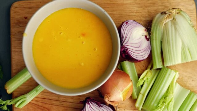 Homemade vegetable soup with ingredients in a bowl 