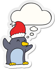 cute cartoon christmas penguin and thought bubble as a printed sticker