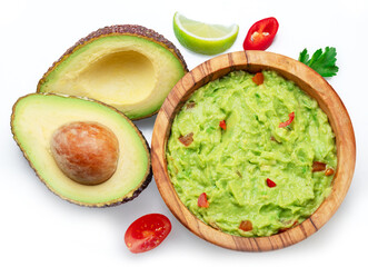 Guacamole and cross section of avocado fruits isolated on white background. Flat lay.