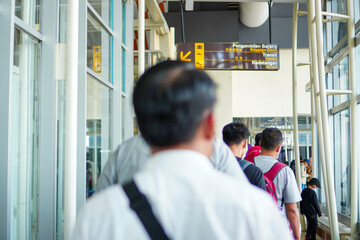 Journey Continues: Passengers Queue Up for Transit at the Airport