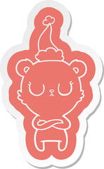 peaceful cartoon  sticker of a polar bear wearing santa hat