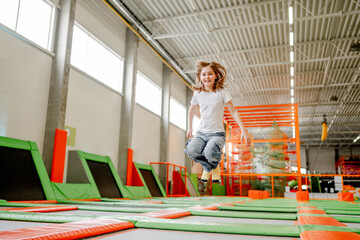 Pretty girl in trampoline park having fun