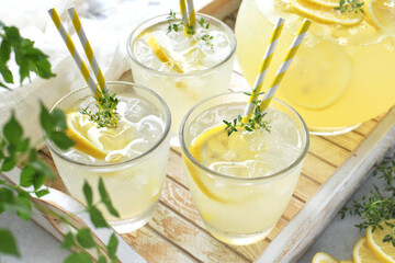 A tray of cool summer drinks, herbal lemonade with  thyme herb, cocktail.