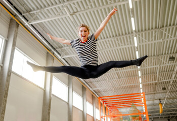 Pretty girl in trampoline park having fun