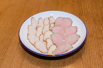 a plate with pieces of smoked meat