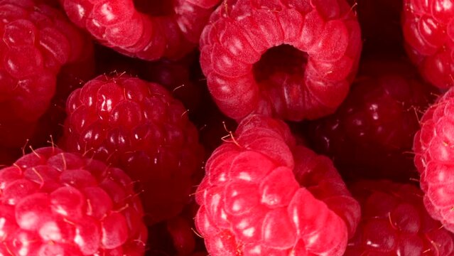 Raspberries turning slowly in close up