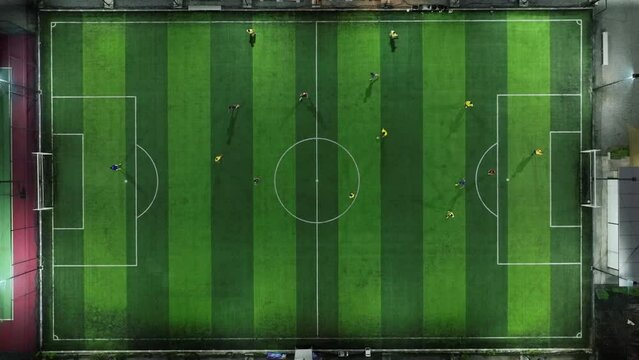 Aerial shots of athletes playing soccer on a soccer field.