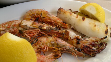 grilled lobster with lemon on plate